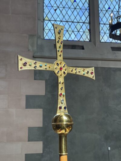 The cross, with the the dent repaired, the jewels cleaned, and the gold polished.