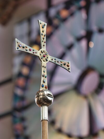 This photo, from Heritage Sunday 2019, shows the cross before its recent restoration and cleaning, with a prominent dent in the orb.